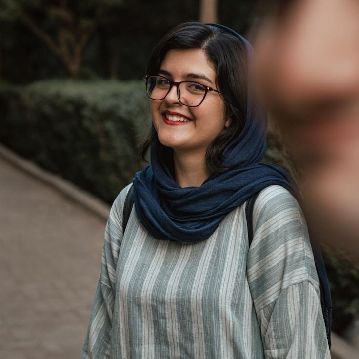 Alex Reed, Lead Design Curator at Meadow Paper Hall, reviewing corporate floral arrangements